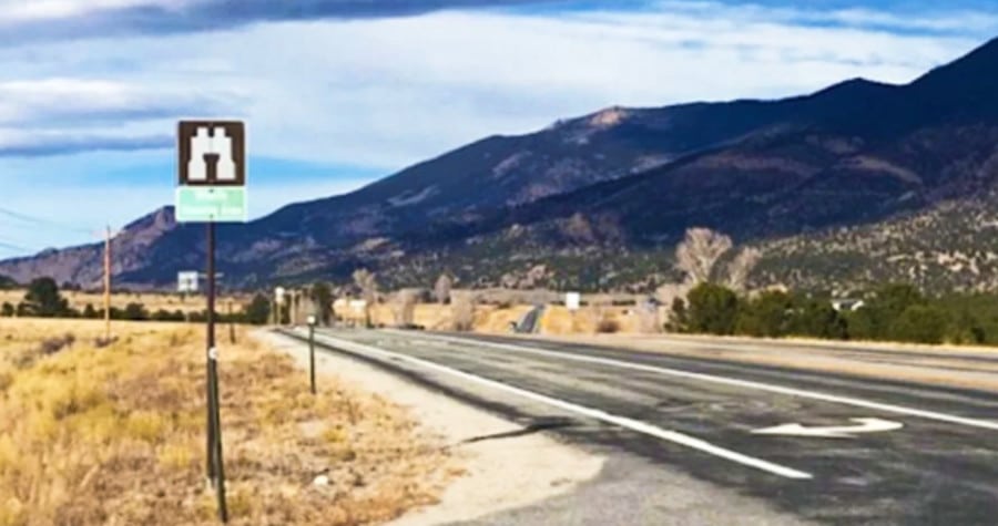 The ghost town of Vicksburg along the highway with a scenic view of the mountains