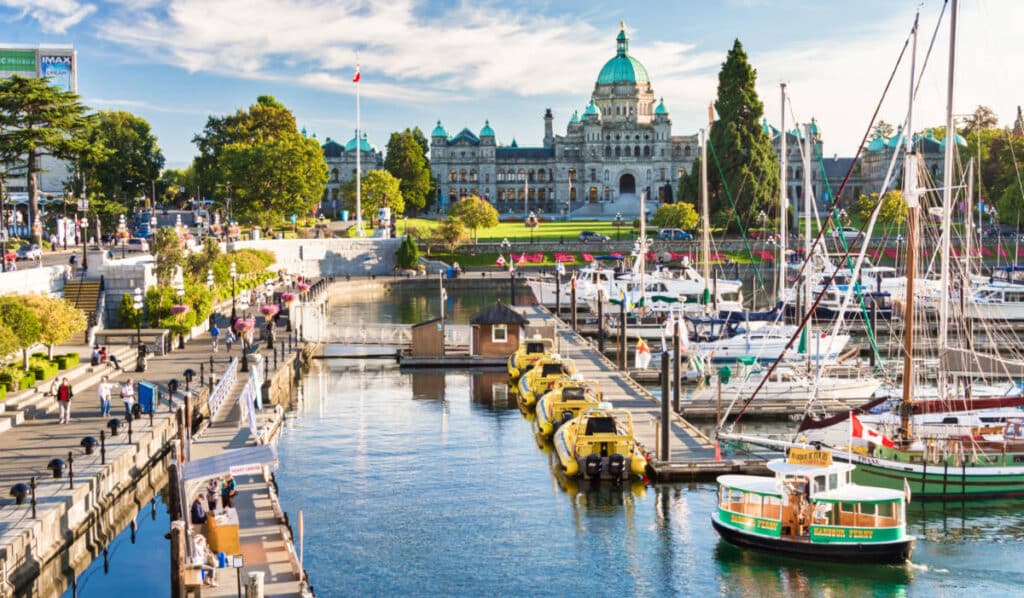 View of the Victoria Harbour and British Columbia Parliament Buildings at sunset