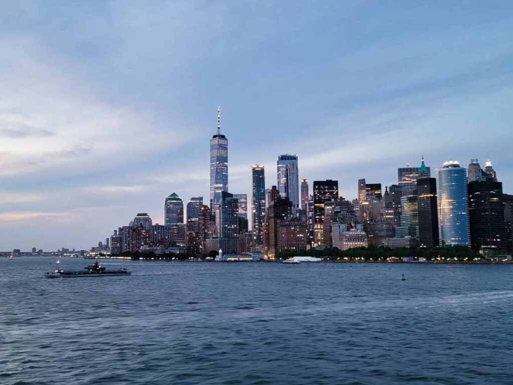 Panoramic view of the Lower New York City from Staten Island Ferry at dusk