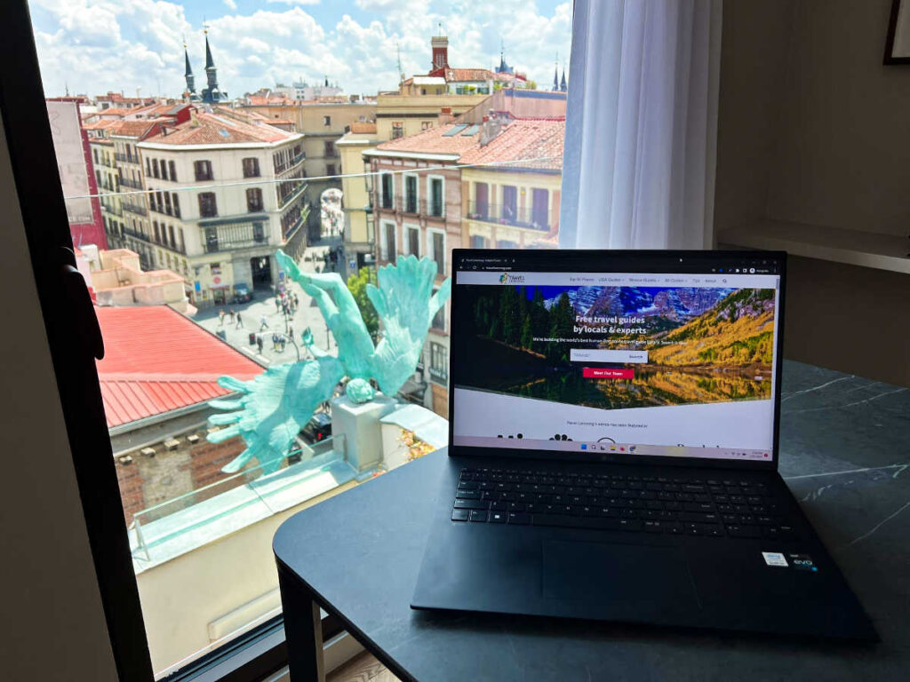 A laptop on the table with an overlooking view from the window