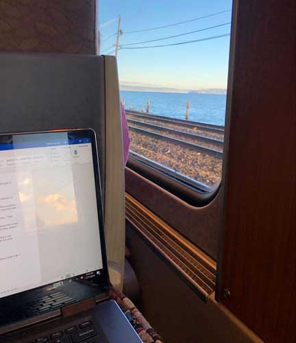 The author working on her laptop while on a train ride to Portland