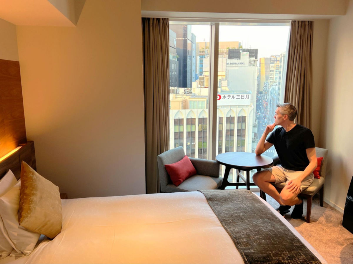 Author Nate looking out of the window at karaksa hotel premier Tokyo Ginza