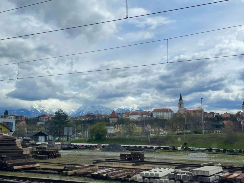 View of buildings and mountains seen from train to Lake Bled