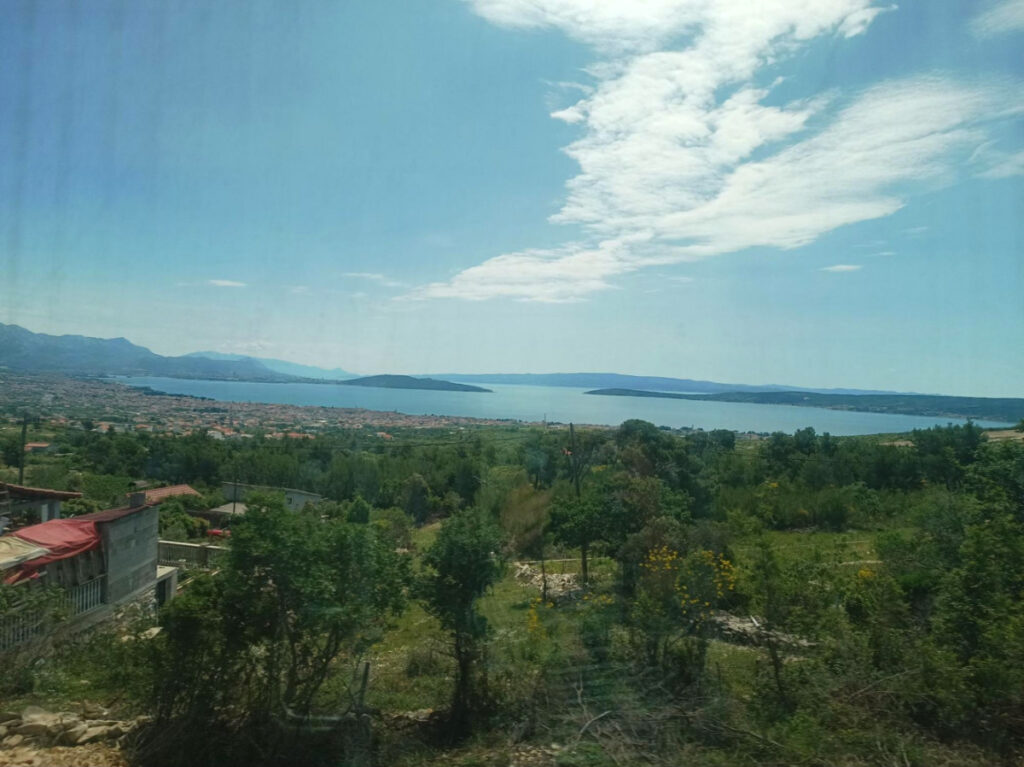 View of lake and mountains seen from train enroute to Split, Croatia