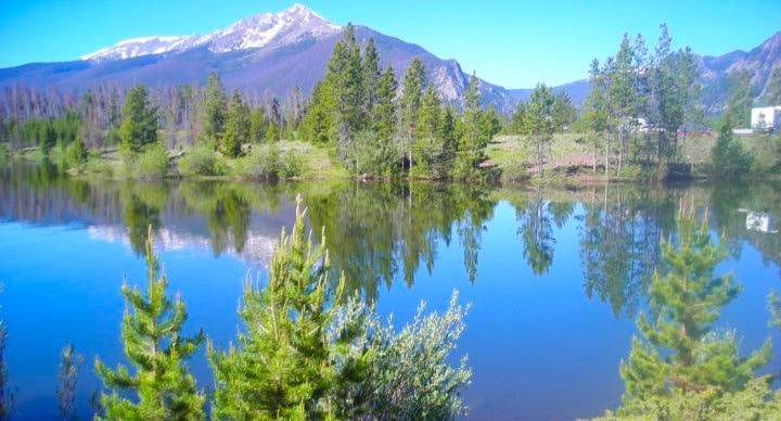 View of Rocky Mountains against a lake in Frisco