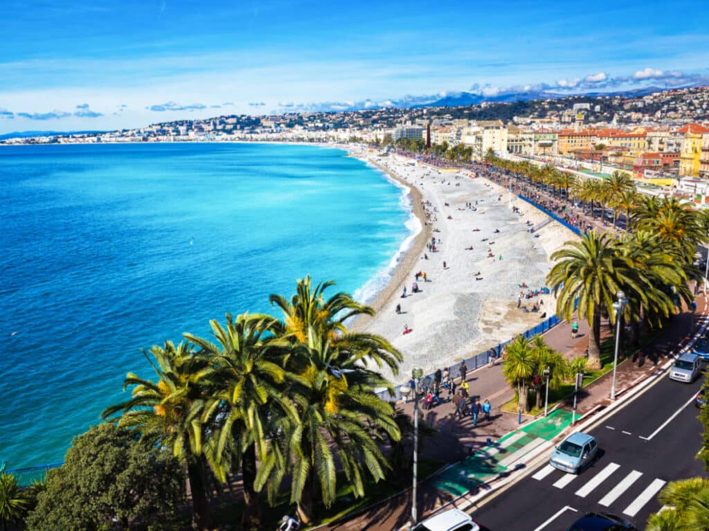 Aerial view of the calm blue ocean and the colorful town of Nice