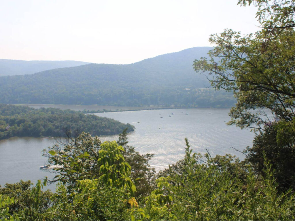 Overlooking view of the Hudson River surrounded by greenery