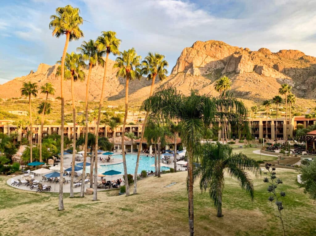 Scenic sunset view of the facade and the pool area of El Conquistador with the magnificent rock mountains in the background