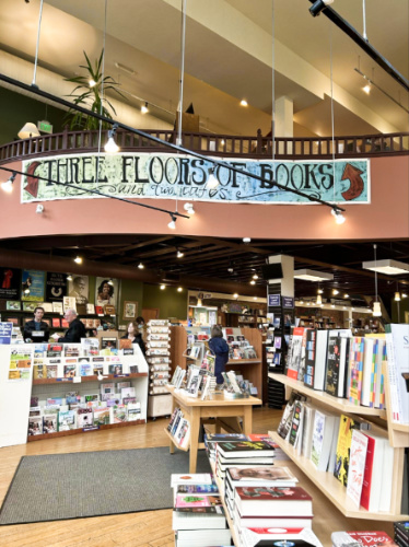 View of the "Three Floors of Books" banner and the displayed books inside the Village Books and Paper Dreams