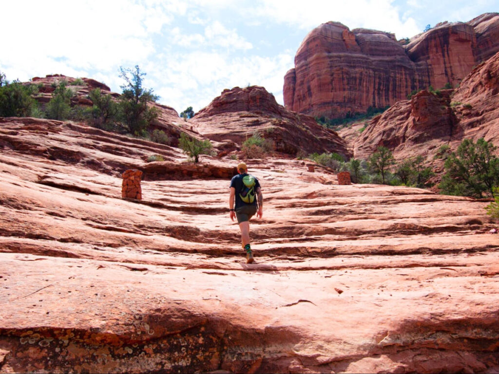 A man hiking to Cathedral with the rock formation views at the top