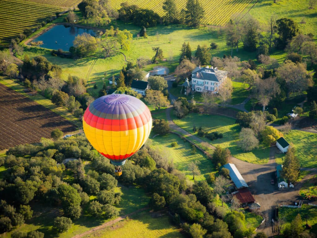 A colorful hot air balloons over a vineyard in Napa Valley, California