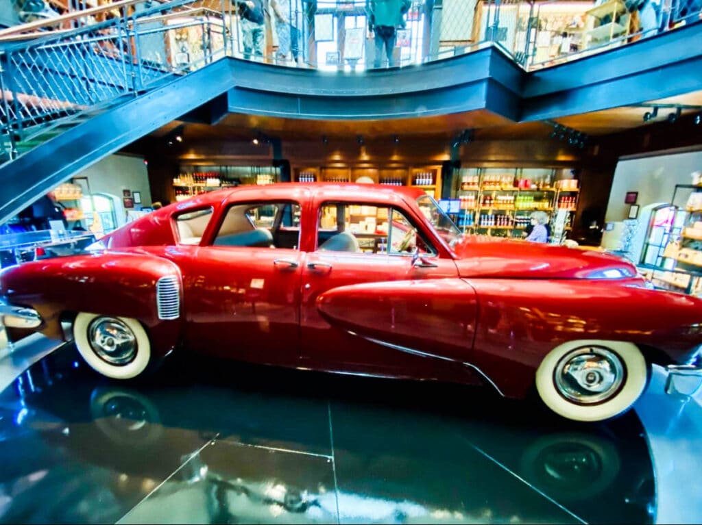 A red vintage car displayed inside the Coppola Winery
