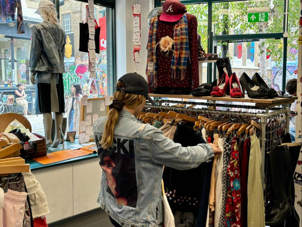 A woman looking at the clothes inside the vintage shop on Brick Lane