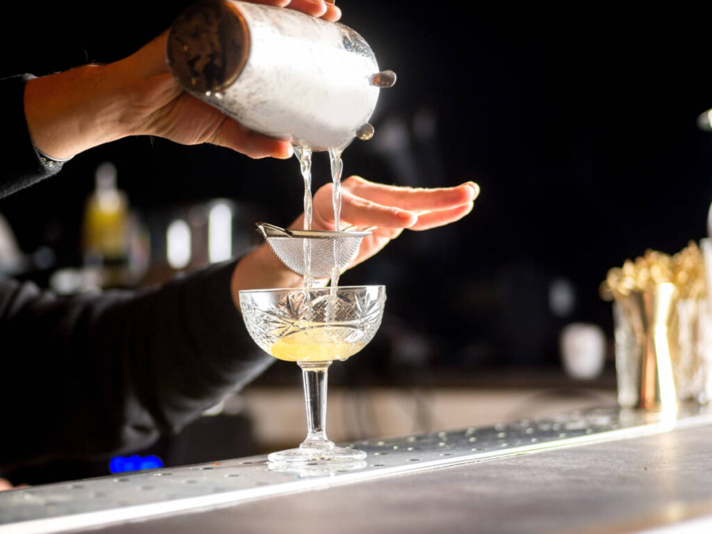 A bartender preparing a cocktail drink in Violet Hour