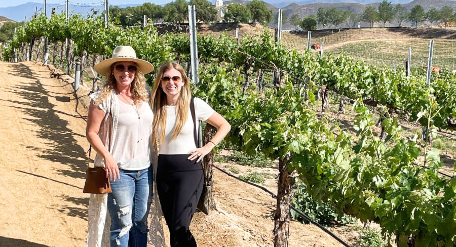 The author Jess Levy and her friend posing in the middle of a vineyard in Temecula