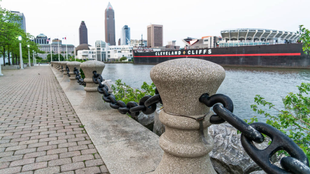 Walk way in Voinovich Bicentennial Park with Cleveland skyline and large steam boat in the background