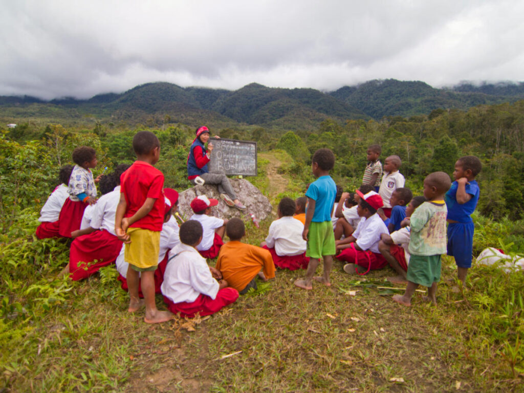 Education volunteer is teaching students and kids in remote area in Indonesia