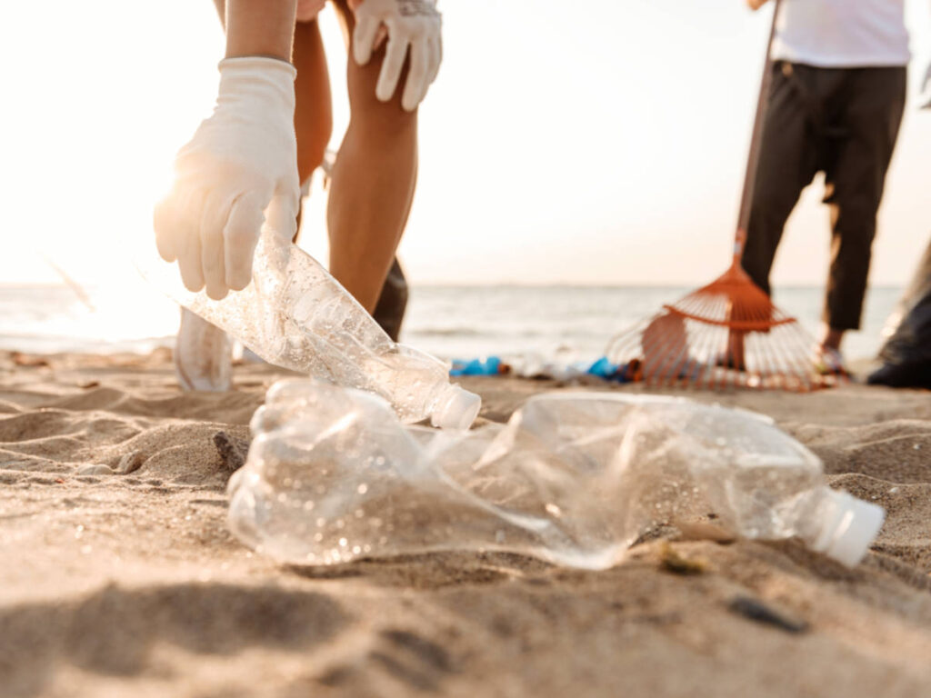 View of the volunteers picking up the plastic bags along the shoreline