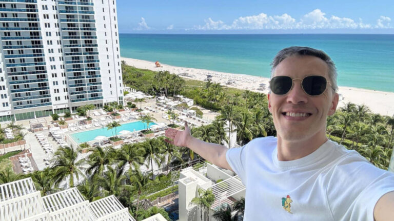 Travel Lemming founder, Nate Hake smiling for a selfie on his balcony at the W South Beach Hotel