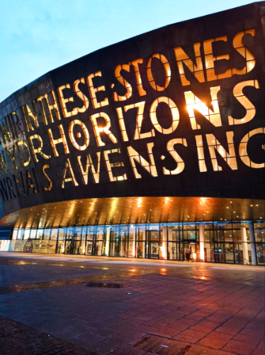 View of the illuminate exterior of Wales Millennium Centre at night