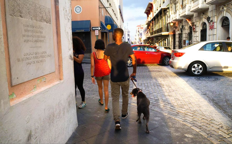 A group of tourist walking in Old San Juan with their dog