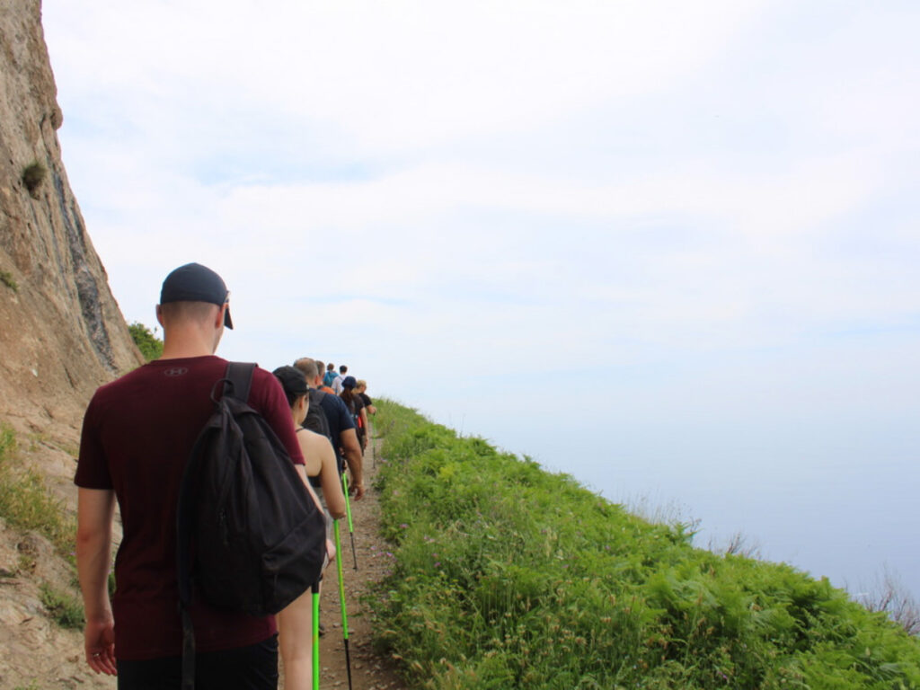 A group of people hiking up a steep hill