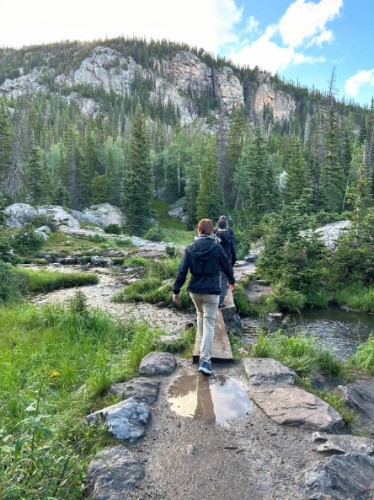 People crossing a river on a trail