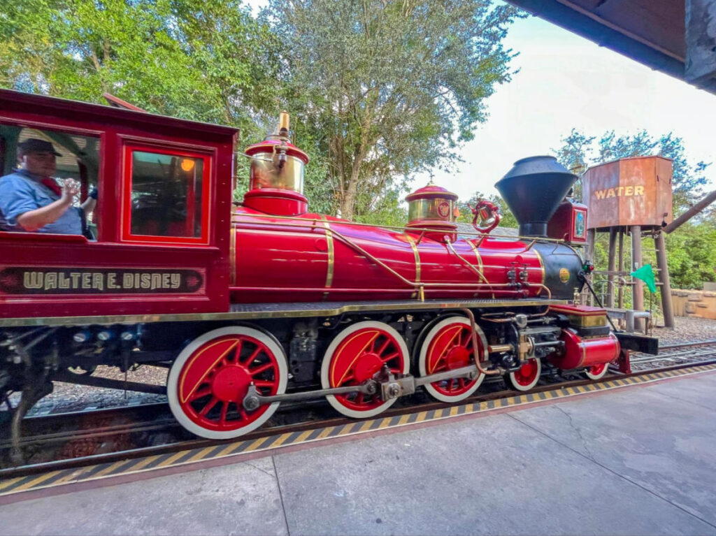 A red train from Walt Disney World Railroad parked at a station