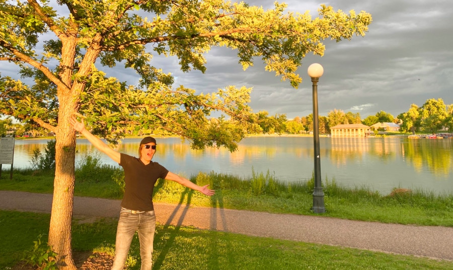 View of the author Nate Hake with arms outstretched in Denver's Washington Park