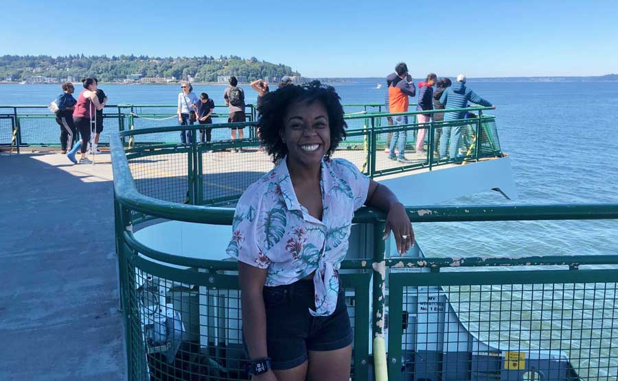 The author smiling for a photo while on the Washington State Ferries going to Bainbridge Island