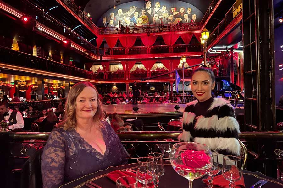Clara and a woman smiling for a photo during a tango show