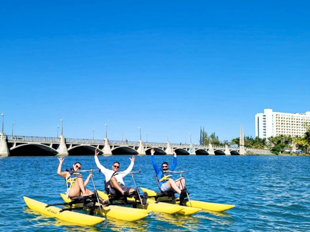 A group of friends on a water bike in the Condado Lagoon