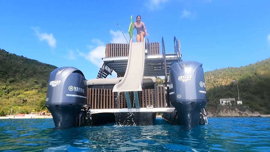The author's wife going on a water slide in Hansen Bay