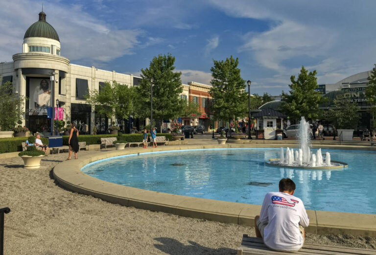 A man in front of a water fountain in Easton Town Center