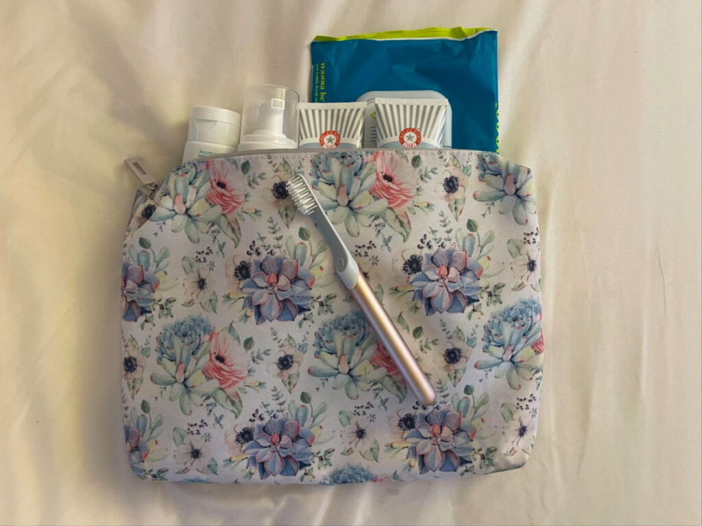 A Water resistant pouch for toiletries with a toothbrush on top of it