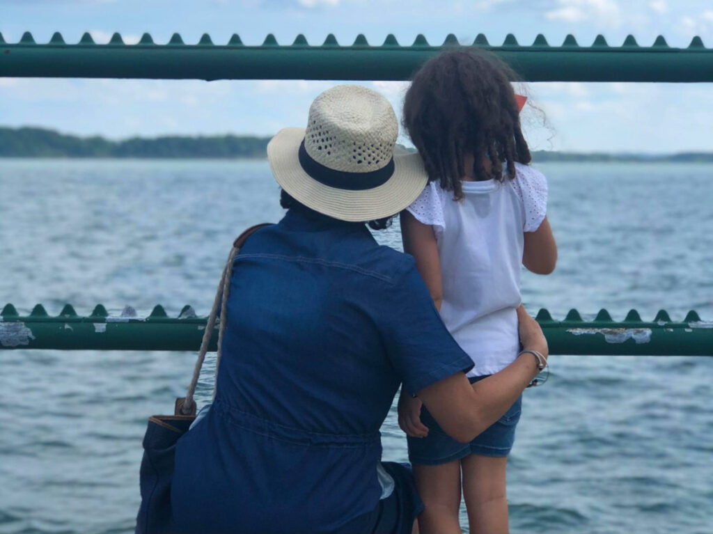 Author Claudicet Pena's mom and daughter admiring the views at a Waterfront boardwalk at Castle Island