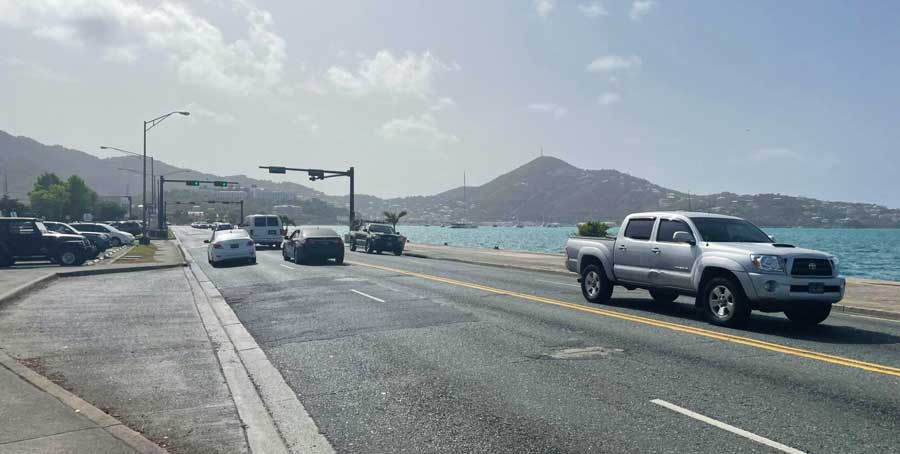 View of cars passing along the waterfront in Charlotte Amalie
