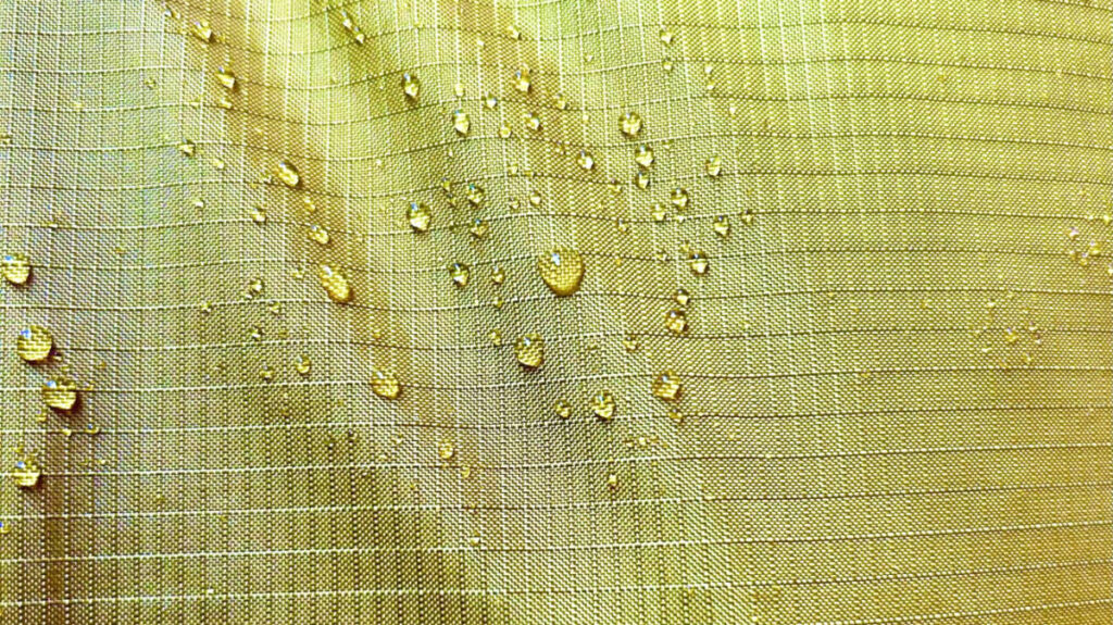 Closeup look at the water in the Robic nylon material of REI Co-Op Flash 55 Backpack