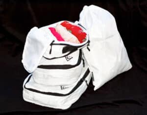 Packed clothes in the Well Traveled Packing Cubes on a black background