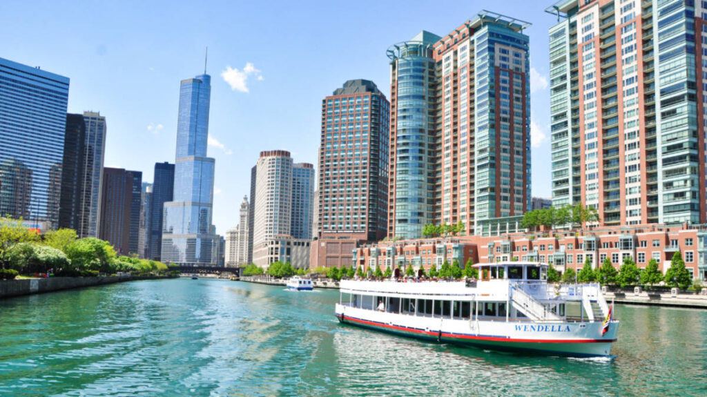 View of the Wendella boat sailing along the Chicago river with the cityscape in the background
