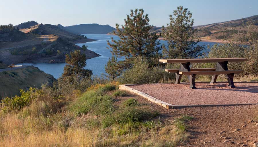 A picnic table with a mountain lake view on West Fort Collins