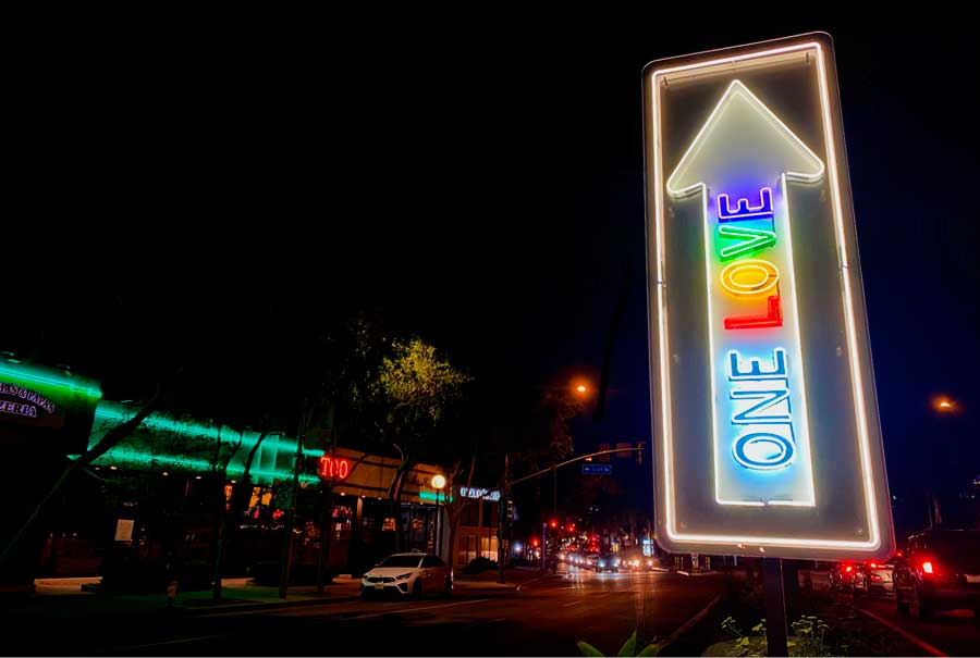 A illuminated sign of One Love in West Holllywood