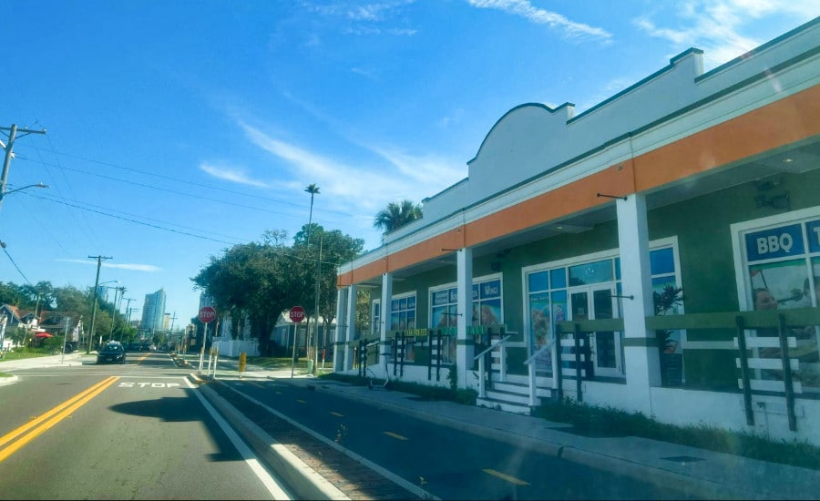 Exterior view of a restaurant and bike lane from the street of West Tampa