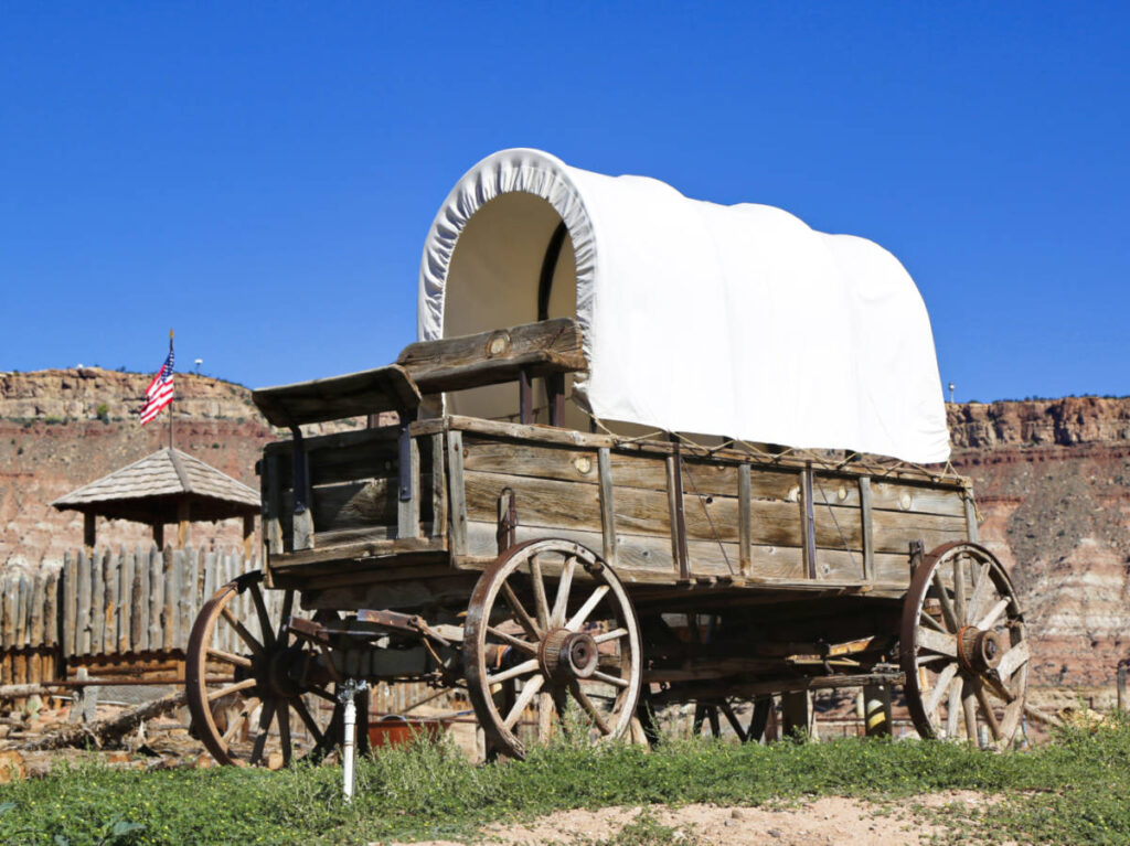 Closeup view of a western wagon with mountain views in the background