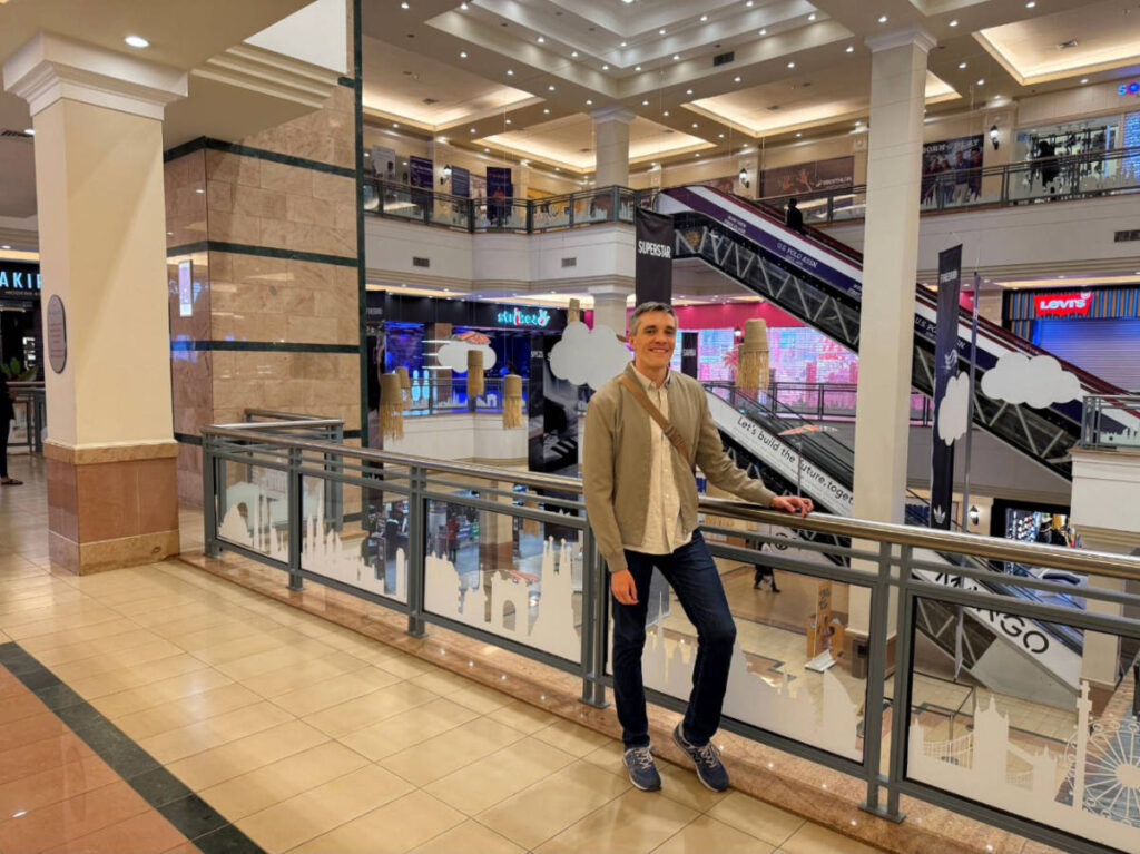 The author Nate Hake smiling for a photo in Westgate Shopping Mall