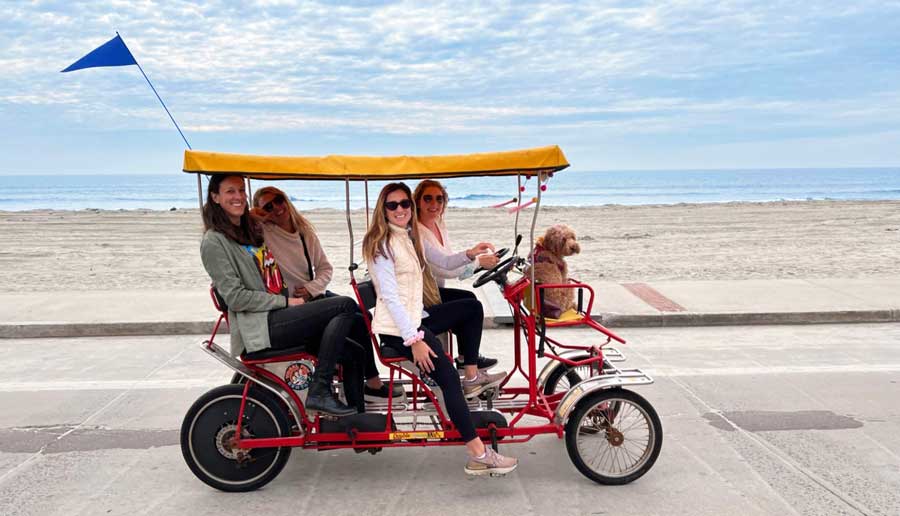 The author Jess with her friend riding a 4-wheel cycle in Oceanside