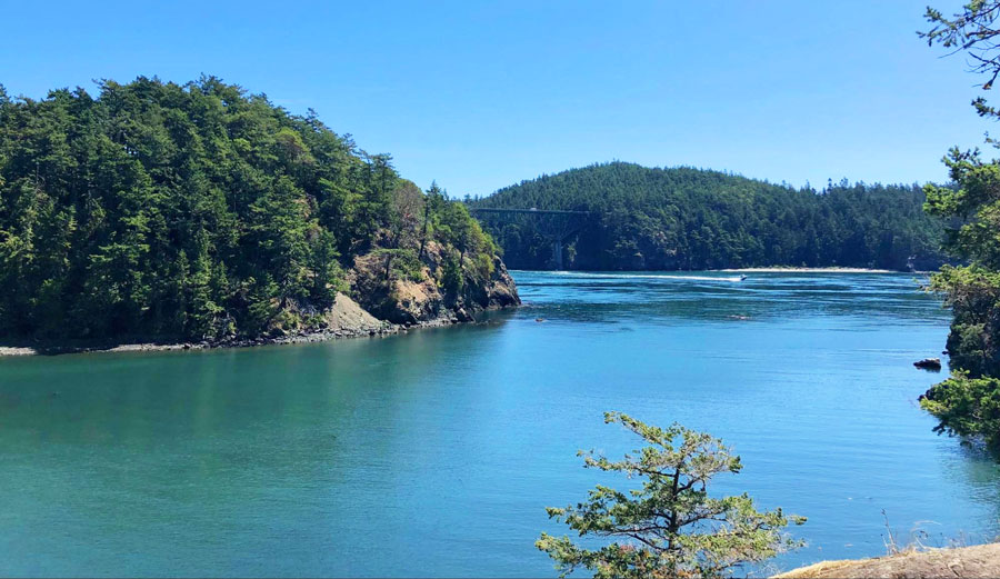 View of blue waters of Deception Pass State Park and its bridge from afar