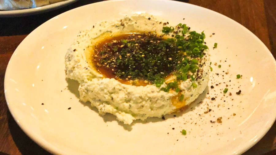 A plate of garnished whipped feta at Butcher and Bee