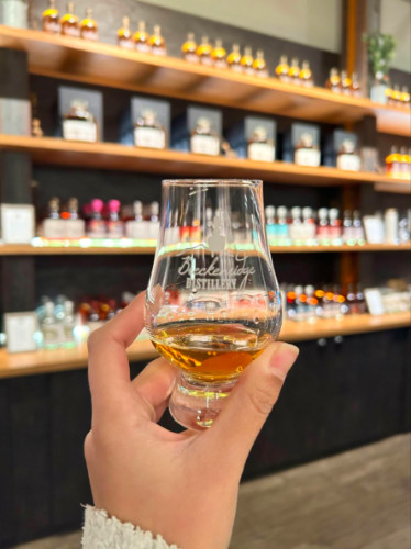Holding a glass of Whiskey at Breckenridge Distillery