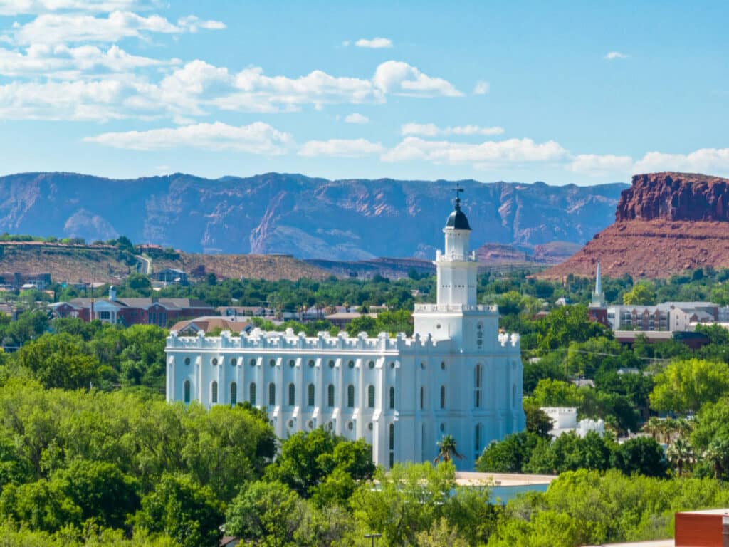 Overlooking view of the white St George Utah Temple surrounded by greenery